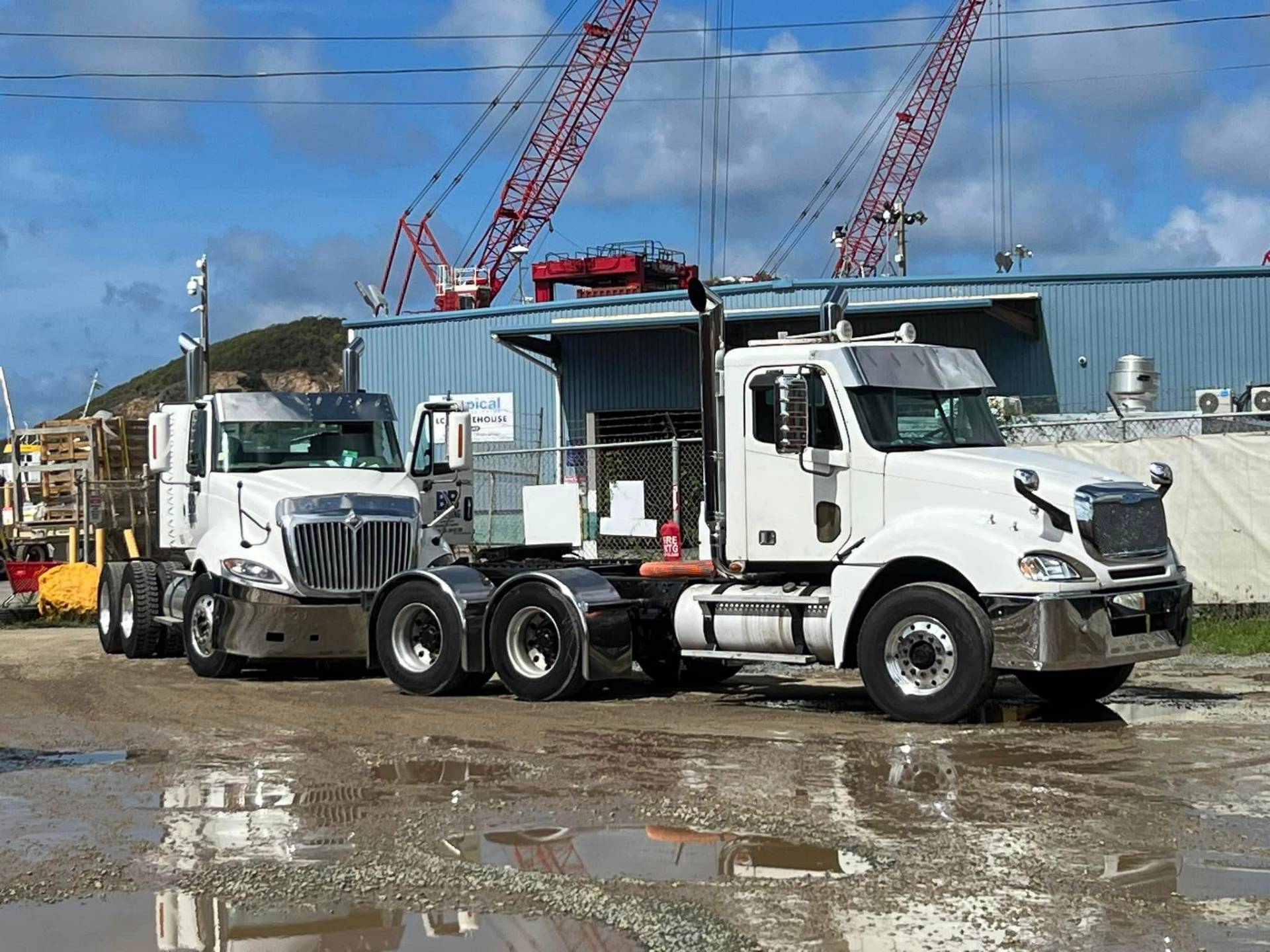 B&B Trucking trucks at a construction site with cranes